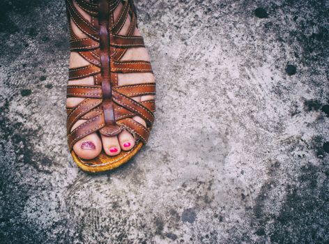 Photograph of a womans foot with a sandal