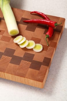 leek and chili pepper on a chopping board