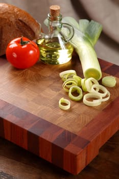 vegetables, vegetable oil and bread on a chopping board