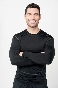 Confident personal trainer smiling over grey