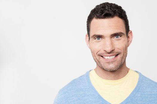 Smiling man posing over grey background