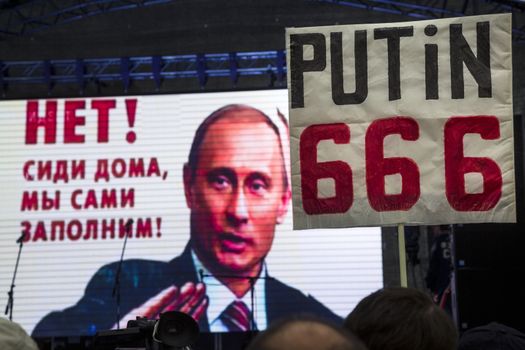 RUSSIA, Moscow: A sign is held saying 'Putin 666' as Russian opposition activists rallied in Moscow on September 20, 2015, in the wake of regional elections that widely favored the ruling United Russia party and prompted accusations of vote rigging. The Meeting to Change Power protest, organised by prominent anti-corruption campaigner Alexei Navalny, drew an estimated 2,000-4,000 people, well short of estimates in advance of the rally. 