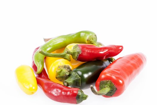 heap of colorful raw chili pepper isolated on white background