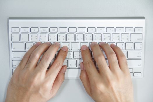 Man with hands on computer keyboard