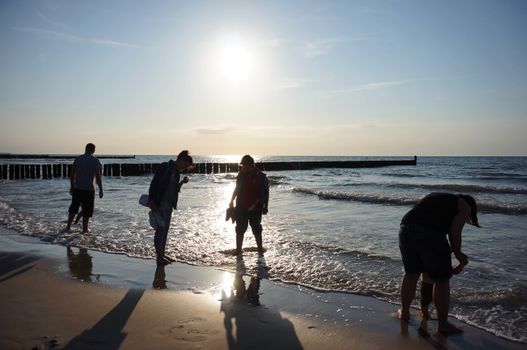 SIANOZETY, POLAND - JULY 18, 2015: Peope standing by the water at a beach in the evening