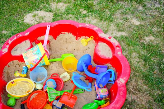 SIANOZETY, POLAND - JULY 19, 2015: Red sand box with plastic toys