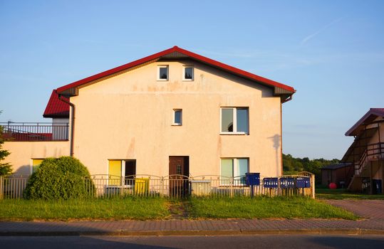 SIANOZETY, POLAND - JULY 18, 2015: House with fence and green grass 