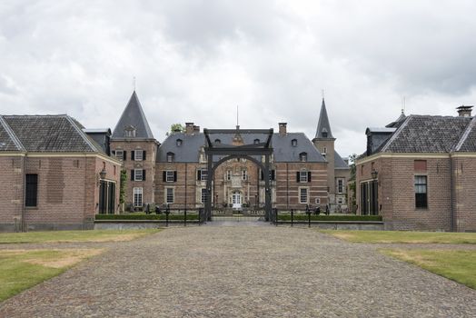 Late medieval castle 'Twickel' with drawbridge and old street near Delden in the Netherlands