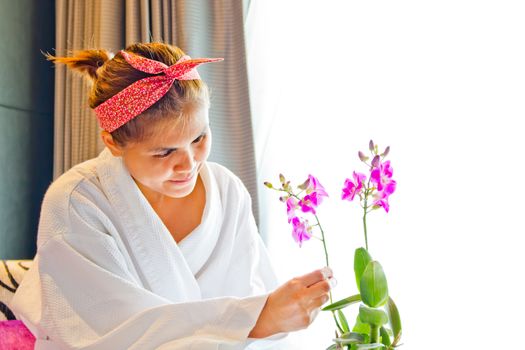 Lady wearing nightgown and flower arrangement in the morning