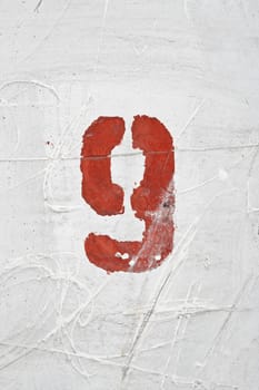 Number on weathered old white wall