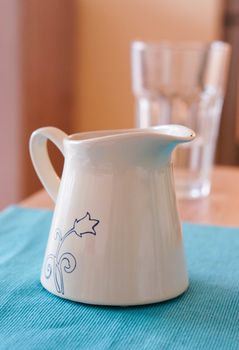 Milk can standing on table