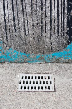 Rain drain and a wall with drawings