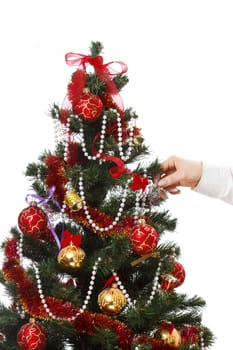 Decorating christmas tree with balls, ribbons and stuff, isolated on white background