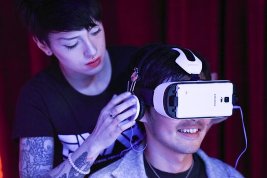 CANADA, Toronto: An assistant helps an man configure a virtual reality headset at the Festival of International Virtual and Augmented Reality Stories on September 19, 2015.  	The festival was an exhibition of virtual reality and augmented films that are experienced through a virtual reality headset.