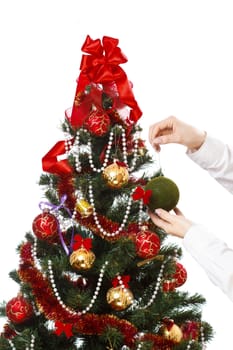 Decorating christmas tree with balls, ribbons and stuff, isolated on white background