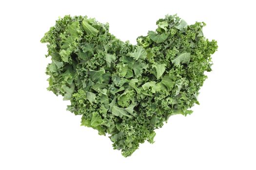 Chopped kale in a heart shape, isolated on a white background