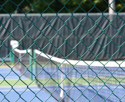 Tennis net through mesh screen