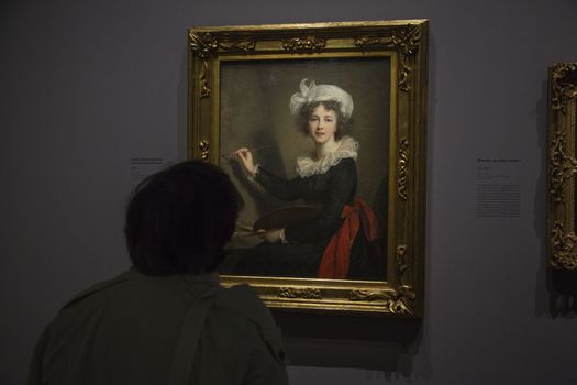 FRANCE, Paris: A woman watches a portrait of �lisabeth Louise Vig�e Le Brun in Le Grand Palais, in Paris on September 21, 2015. �lisabeth Louise Vig�e Le Brun (1755-1842) is one of the greater portrait painter of her time. She was chosen to paint the very famous queen of France Marie-Antoinette. 