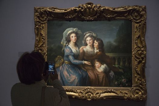 FRANCE, Paris: A woman watches a portrait of �lisabeth Louise Vig�e Le Brun in Le Grand Palais, in Paris on September 21, 2015. �lisabeth Louise Vig�e Le Brun (1755-1842) is one of the greater portrait painter of her time. She was chosen to paint the very famous queen of France Marie-Antoinette. 