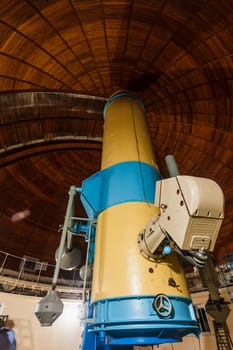 Old trophy large optical telescope at display