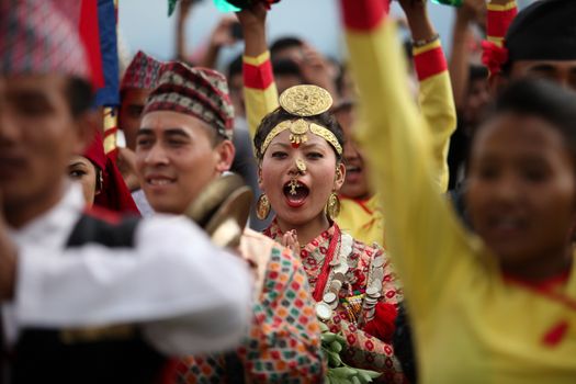 NEPAL, Kathmandu: A woman chants at celebrations in Kathmandu, Nepal on September 21, 2015, one day after the government unveiled the country's first democratic constitution in a historic step. Out of the 598 members of the Constituent Assembly, 507 voted for the new constitution, 25 voted against, and 66 abstained in a vote on September 16, 2015. The event was marked with fireworks and festivities, but also with protests organized by parties of the Tharu and Madhesi ethnic communities.Photos taken by Newzulu contributor Dinesh Shrestha show the Nepalese people donning traditional garb and celebrating with folk music and dancing.