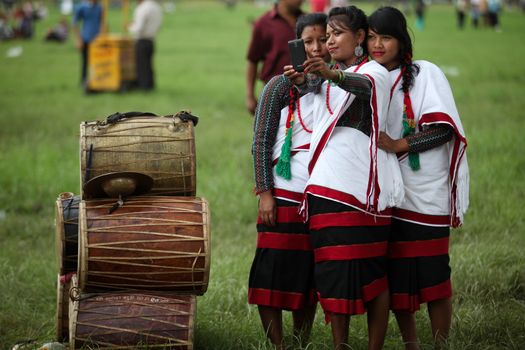 NEPAL, Kathmandu: Women wearing traditional clothing take a selfie at celebrations in Kathmandu, Nepal on September 21, 2015, one day after the government unveiled the country's first democratic constitution in a historic step. Out of the 598 members of the Constituent Assembly, 507 voted for the new constitution, 25 voted against, and 66 abstained in a vote on September 16, 2015. The event was marked with fireworks and festivities, but also with protests organized by parties of the Tharu and Madhesi ethnic communities.Photos taken by Newzulu contributor Dinesh Shrestha show the Nepalese people donning traditional garb and celebrating with folk music and dancing.