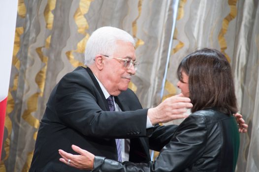 FRANCE, Paris : Palestinian Authority president Mahmoud Abbas (L) embraces Paris' mayor Anne Hidalgo prior to a meeting on the occasion of the International Day of Peace on September 21, 2015 at Paris' city hall. 