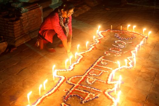 NEPAL, Kathmandu: A woman lights candles at a celebration in Kathmandu, Nepal on September 21, 2015, one day after the government unveiled the country's first democratic constitution in a historic step. Out of the 598 members of the Constituent Assembly, 507 voted for the new constitution, 25 voted against, and 66 abstained in a vote on September 16, 2015. The event was marked with fireworks and festivities, but also with protests organized by parties of the Tharu and Madhesi ethnic communities.Photos taken by Newzulu contributor Dinesh Shrestha show the Nepalese people lighting candles to mark new chapter in the history of their country.