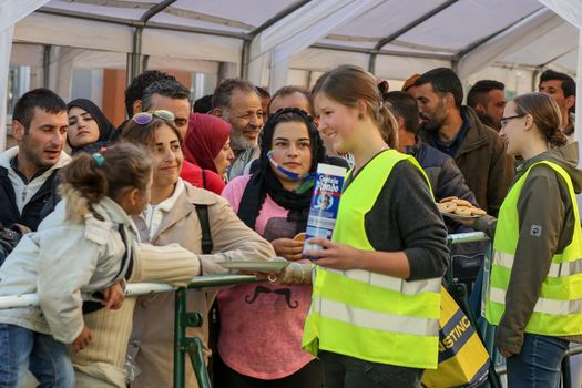  GERMANY, Passau: Volunteers tend to refugees standing in long queues in the border town of Passau, Germany on September 21, 2015 amid the reintroduction of border controls in Germany, Austria, and a number of other EU countries, aimed at slowing the flow of refugees from war-torn Syria.