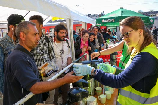 GERMANY, Passau: Volunteers tend to refugees standing in long queues in the border town of Passau, Germany on September 21, 2015 amid the reintroduction of border controls in Germany, Austria, and a number of other EU countries, aimed at slowing the flow of refugees from war-torn Syria.