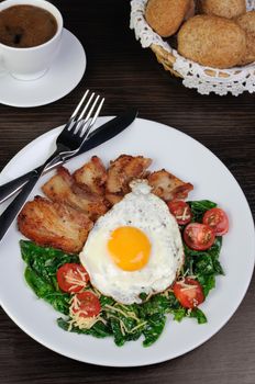 Scrambled eggs with bacon and spinach, cheese and cherry tomatoes