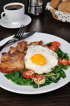 Scrambled eggs with bacon and spinach, cheese and cherry tomatoes