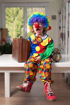 Little boy dressed as a clown with a surprised expresion