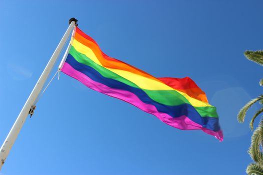 Rainbow Gay Pride Flag on Blue Sky Background. Nice, France