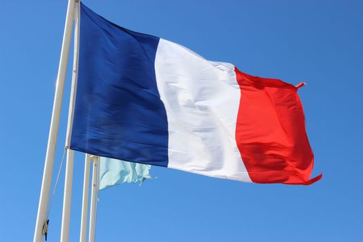 Flag of France waving against Blue Sky. Nice, France