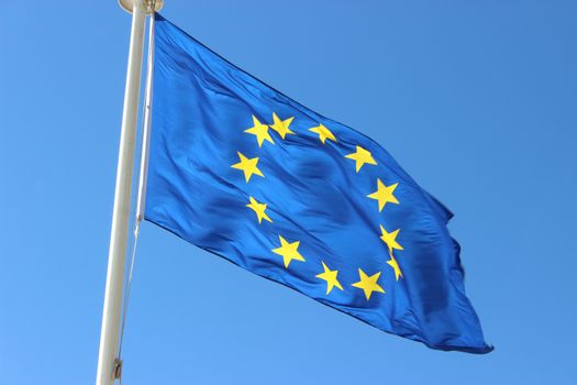 European Union Flag on Blue Sky Background
