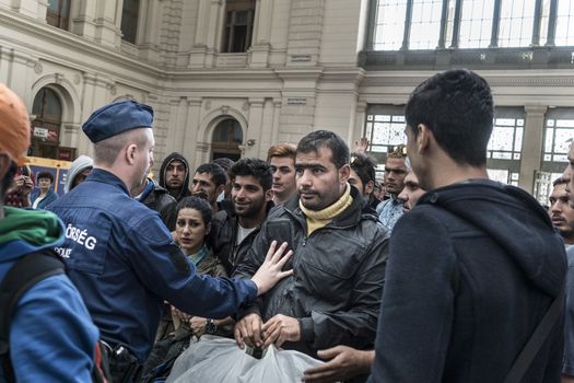 HUNGARY, Roszke: A man is held back by police as refugees crowd Budapest's Keleti Train Station on September 8 2015, as Europe's refugee crisis continues. 