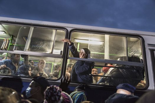 HUNGARY, Roszke: Refugees are placed on a bus as the difficulties of living in Hungary's Roszke refugee camp is documented between September 8 and 12, 2015, as Europe's refugee crisis continues. 