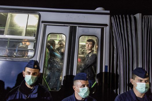 HUNGARY, Roszke: A man looks out the bus window while being taken away to a registration camp as the difficulties of living in Hungary's Roszke refugee camp is documented between September 8 and 12, 2015, as Europe's refugee crisis continues. 