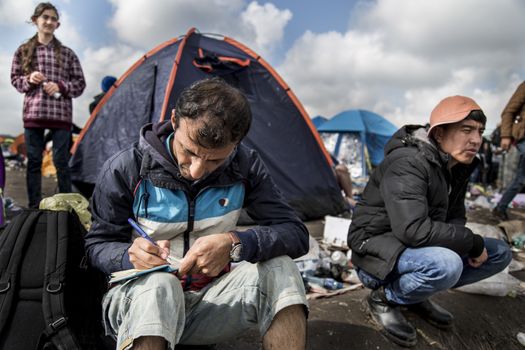 HUNGARY, Roszke: A man writes in his diary as the difficulties of living in Hungary's Roszke refugee camp is documented between September 8 and 12, 2015, as Europe's refugee crisis continues. 