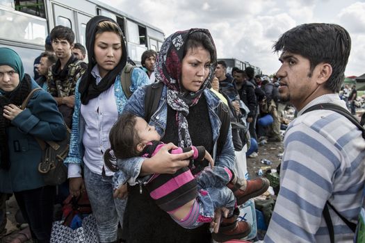 HUNGARY, Roszke: A woman carries her baby as the difficulties of living in Hungary's Roszke refugee camp border camps is documented between September 8 and 12, 2015, as Europe's refugee crisis continues. 