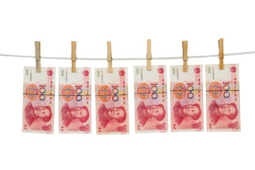 Money laundering concept with China notes on clothesline in plain isolated white background.
