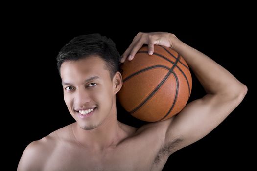 Asian young basketball player on black background