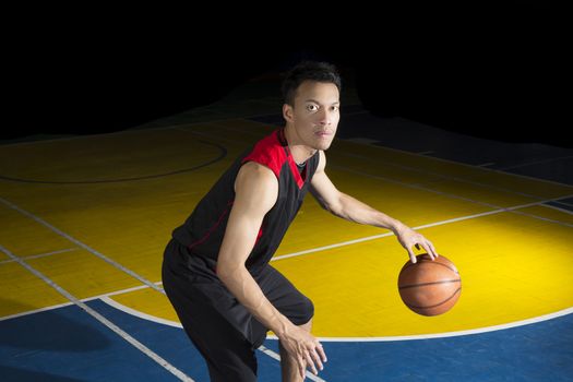 Asian young basketball player on basketball court