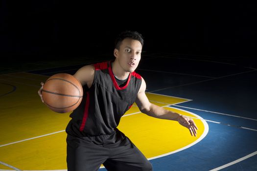 Asian young basketball player on basketball court