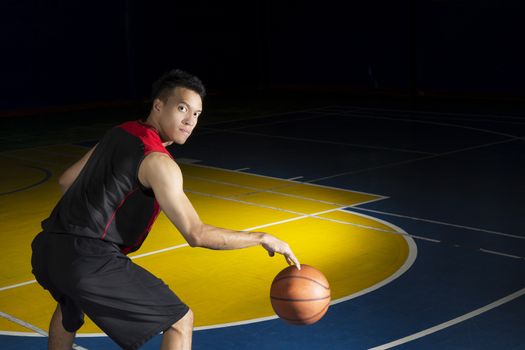 Asian young basketball player on basketball court