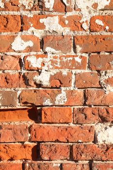 Closeup of old red brick wall under sunlight