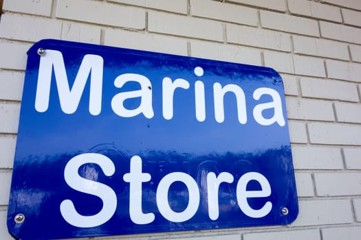 boat marina store sign on brick masonry wall