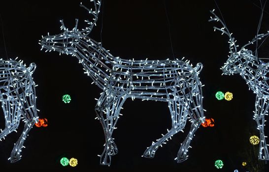 white glowing electronic deer in the sleigh of Santa Claus delivering gifts