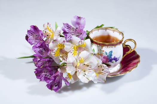 Cup of tea and bouquet of flowers